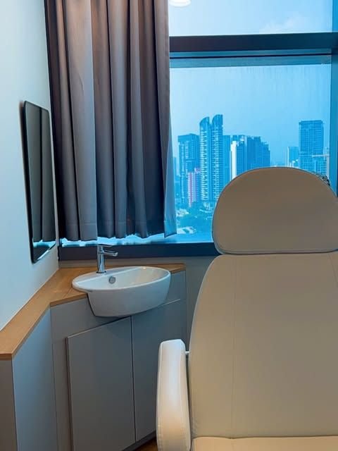 Cream treatment chair by a window overlooking the city