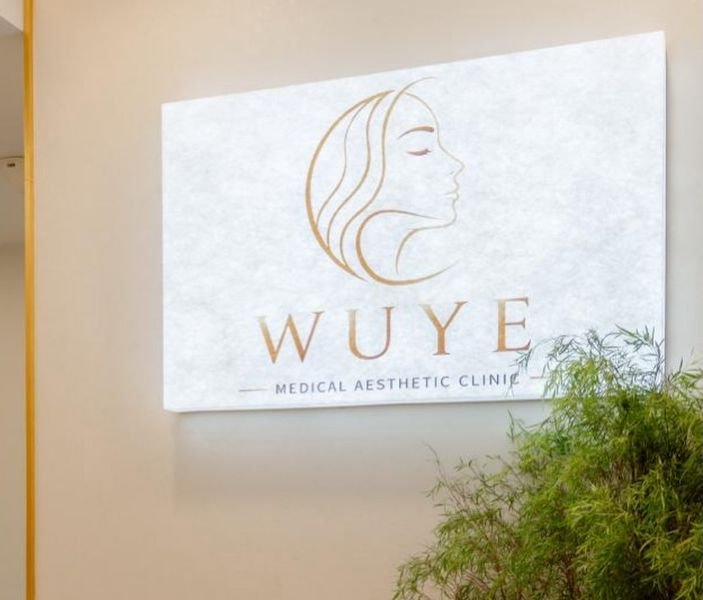 Illuminated WUYE Medical Aesthetic Clinic sign at reception