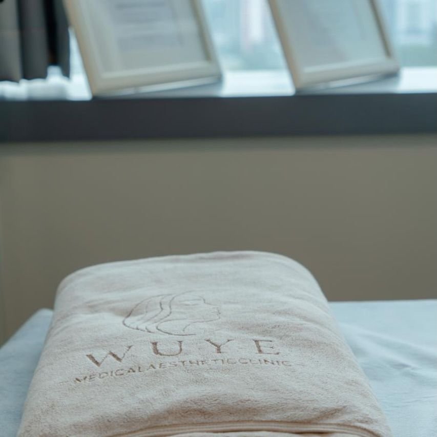 Cream towel embroidered with the WUYE logo