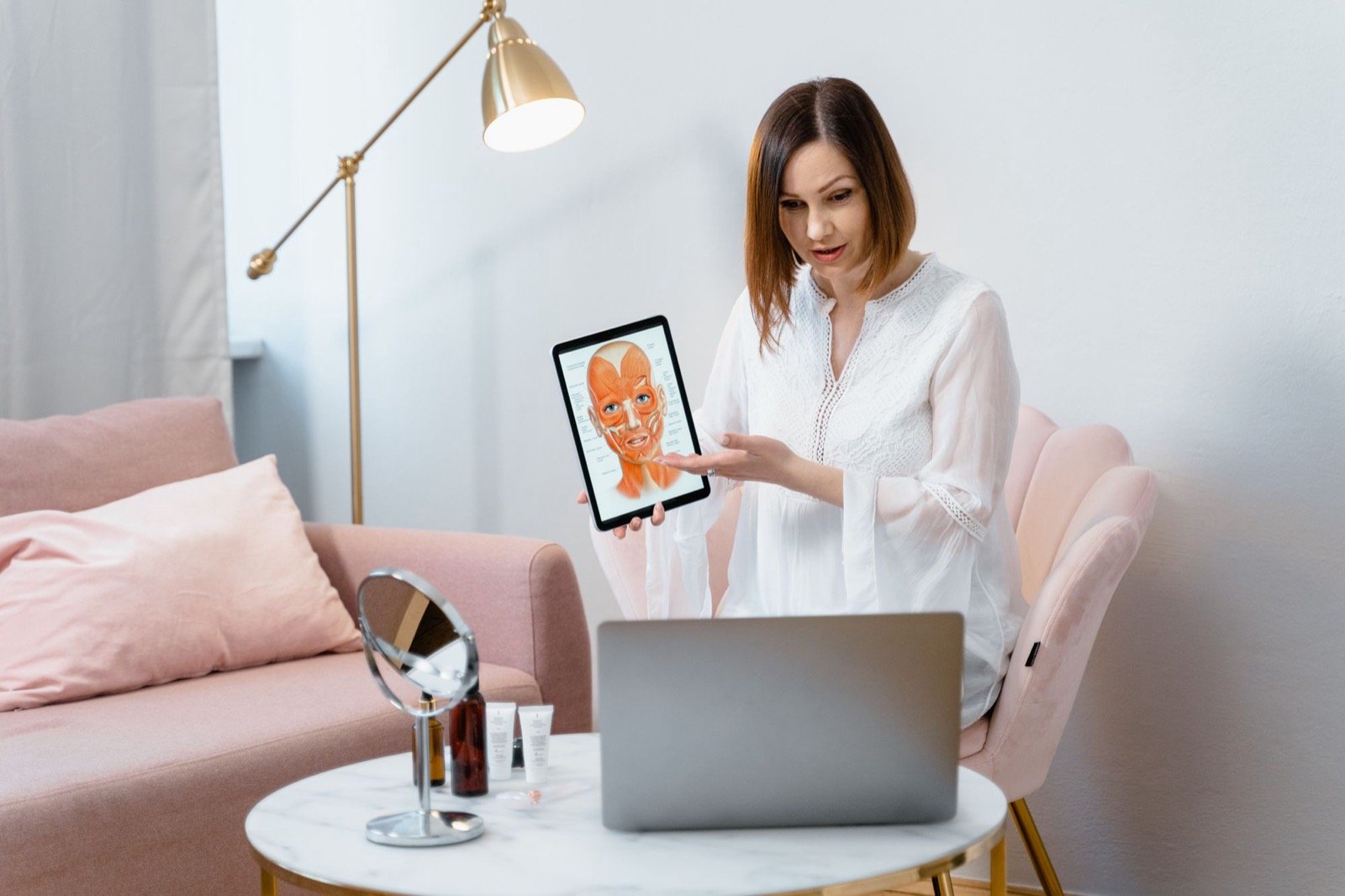 Practitioner reviewing a facial treatment plan on a tablet